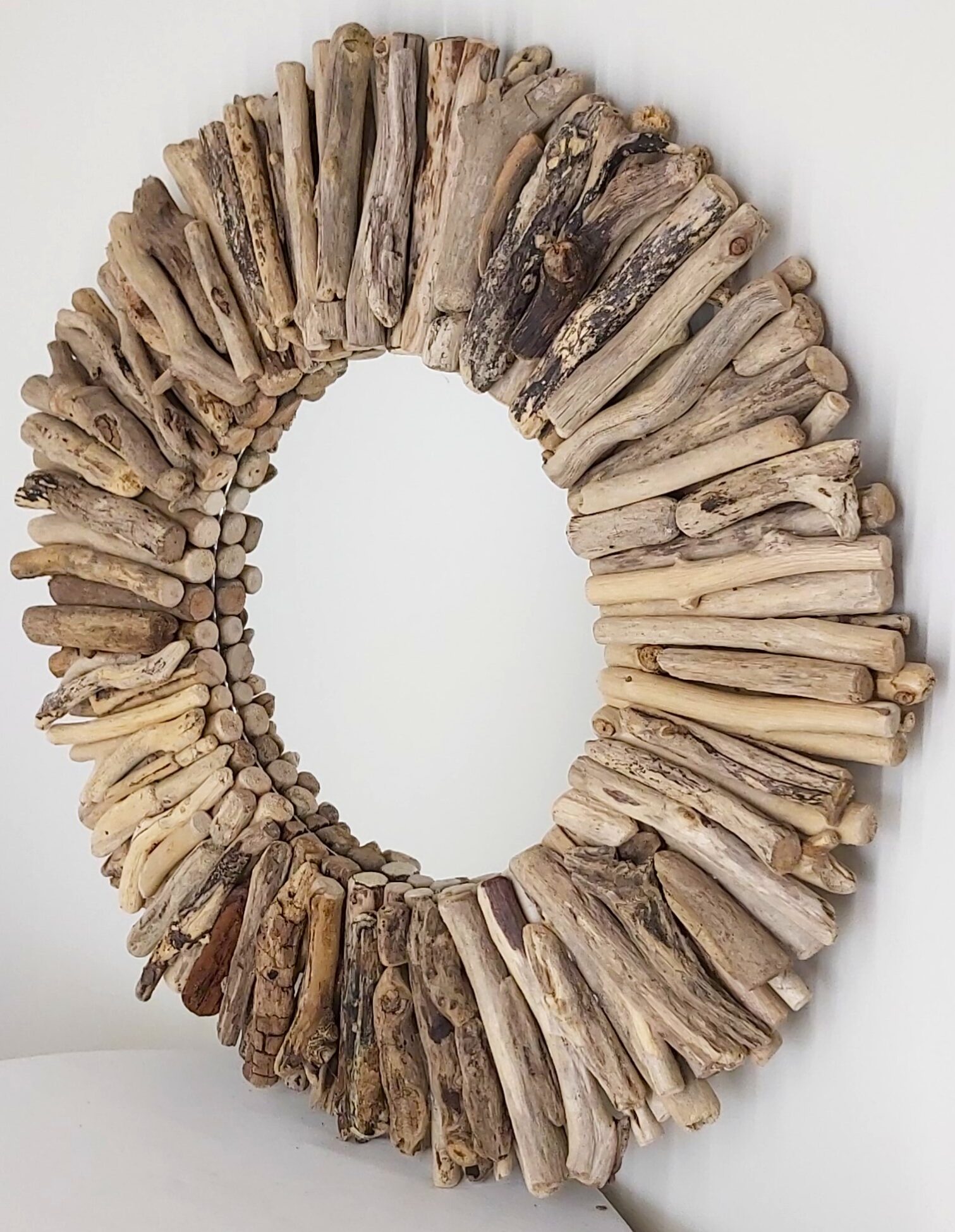 This driftwood mirror titled Beach Days uses a mixture of gold coloured wood