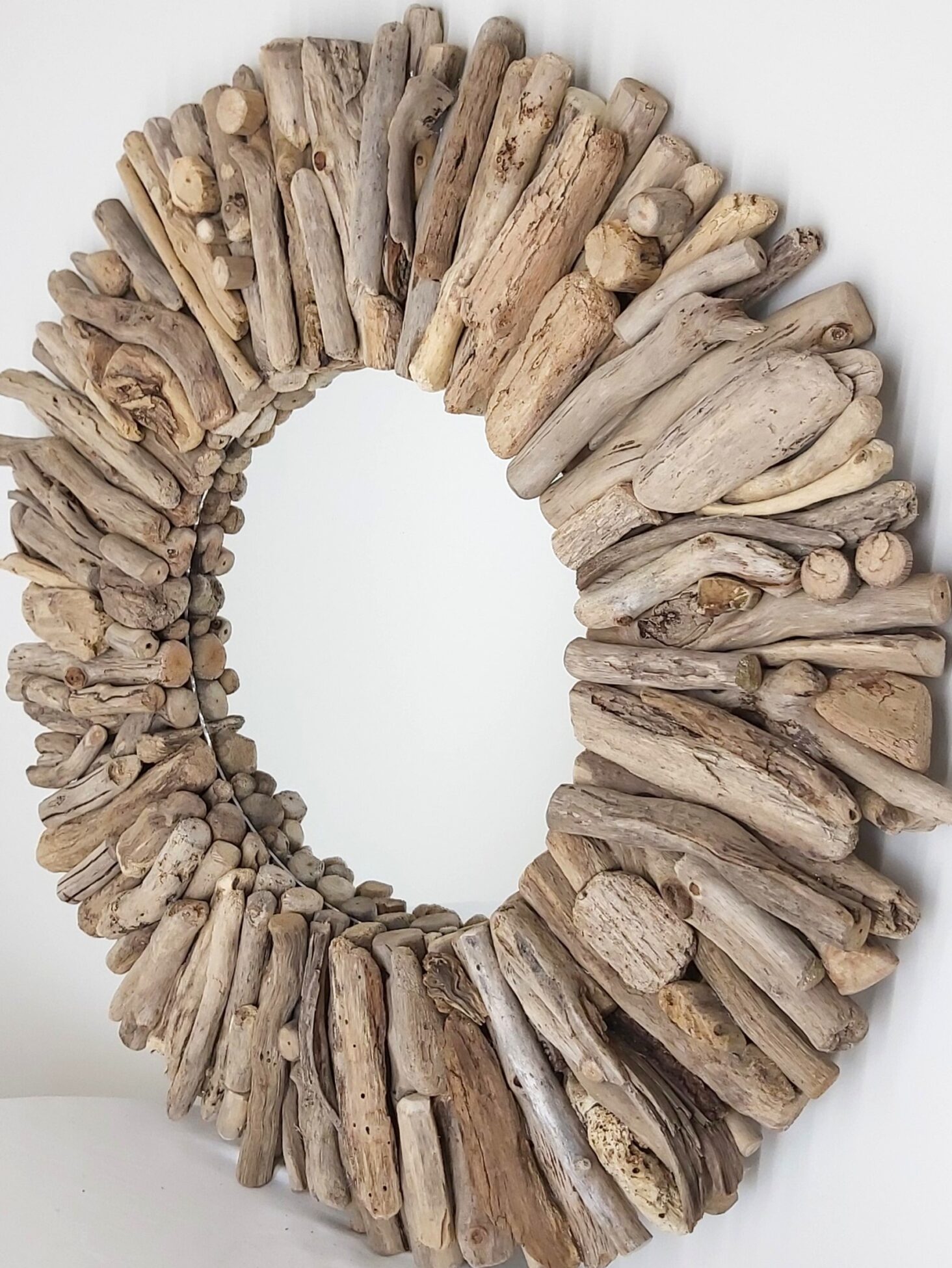 This driftwood mirror titled Beach Memories uses a mixture of gold woods