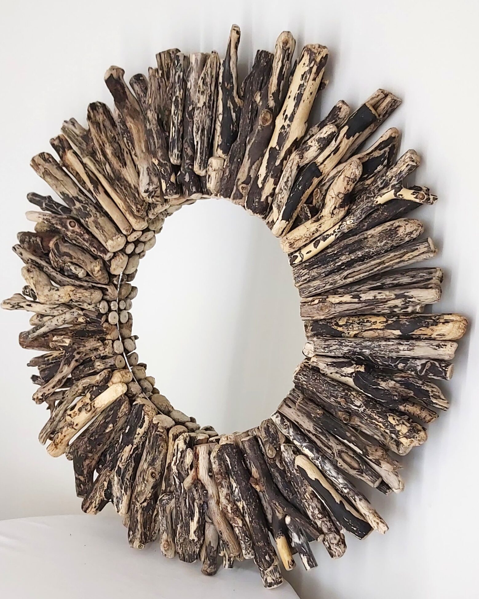This driftwood mirror titled Midnight uses mottled sycamore wood.