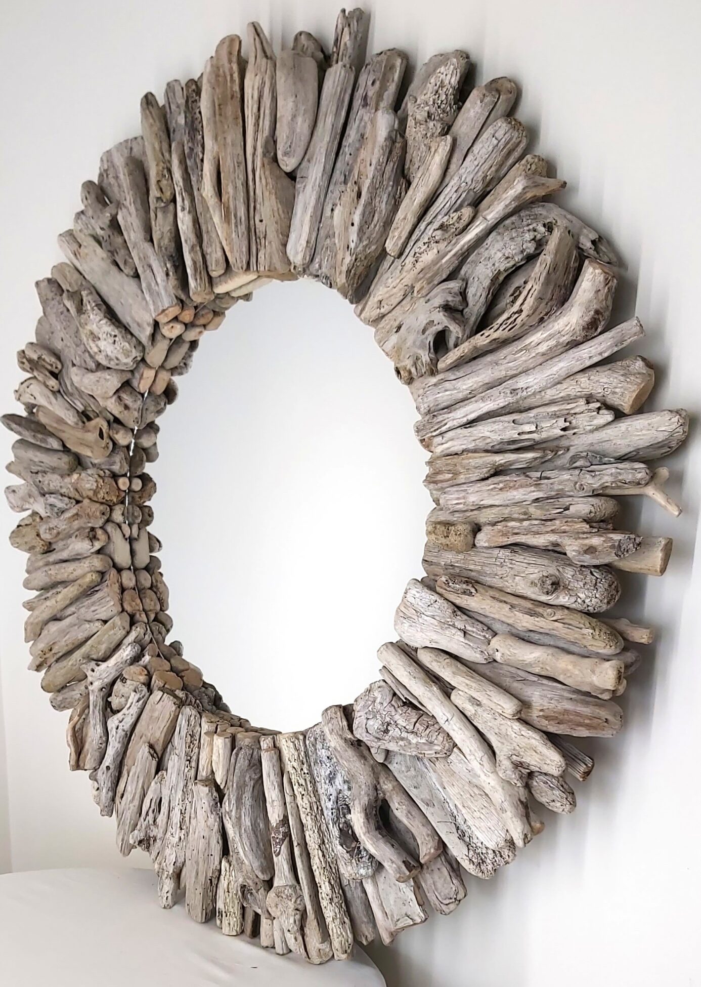 This driftwood mirror titled Salt Licked uses white and light grey woods