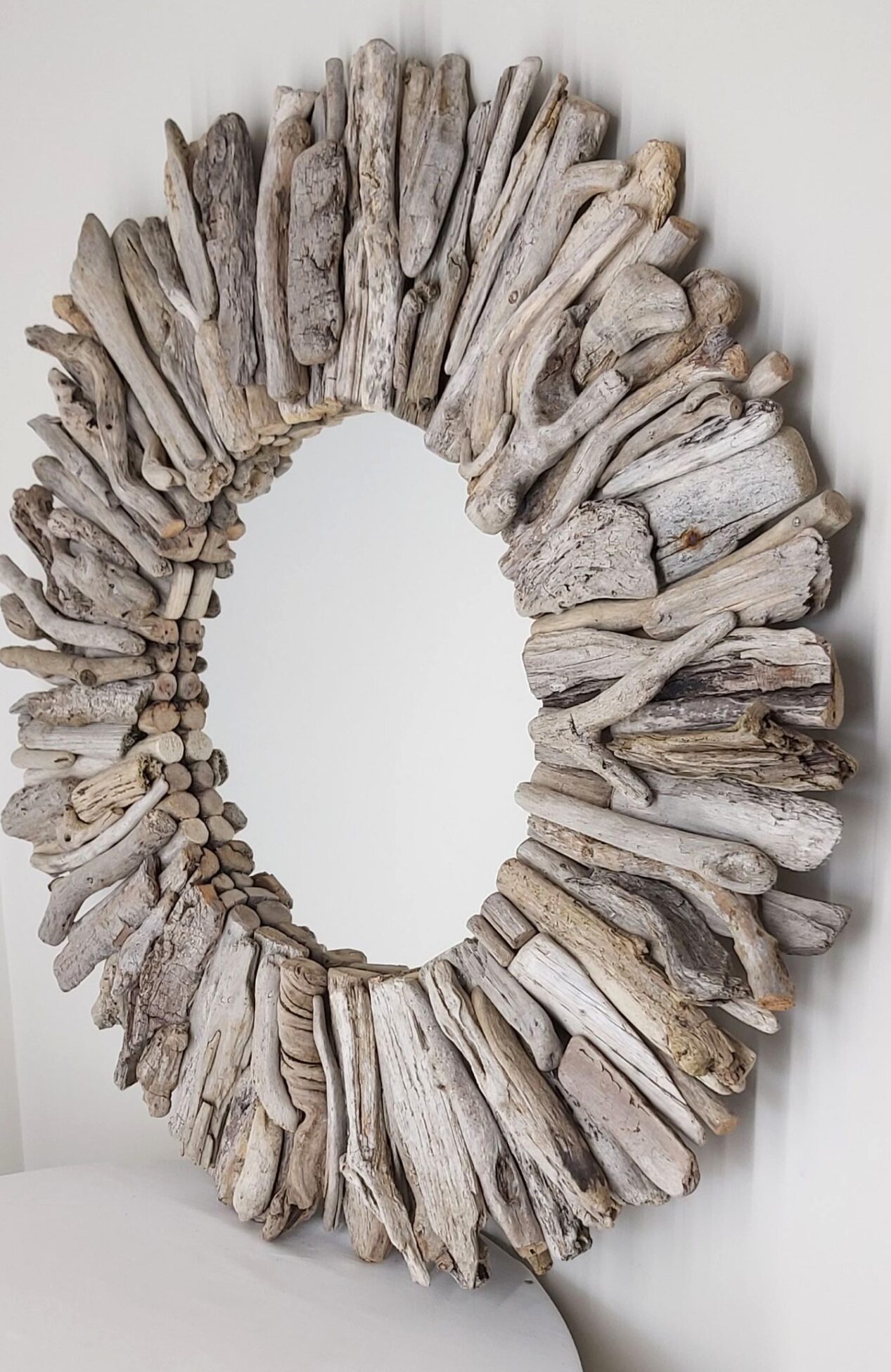 This driftwood mirror titled Salt Spray uses a mixture of light grey woods