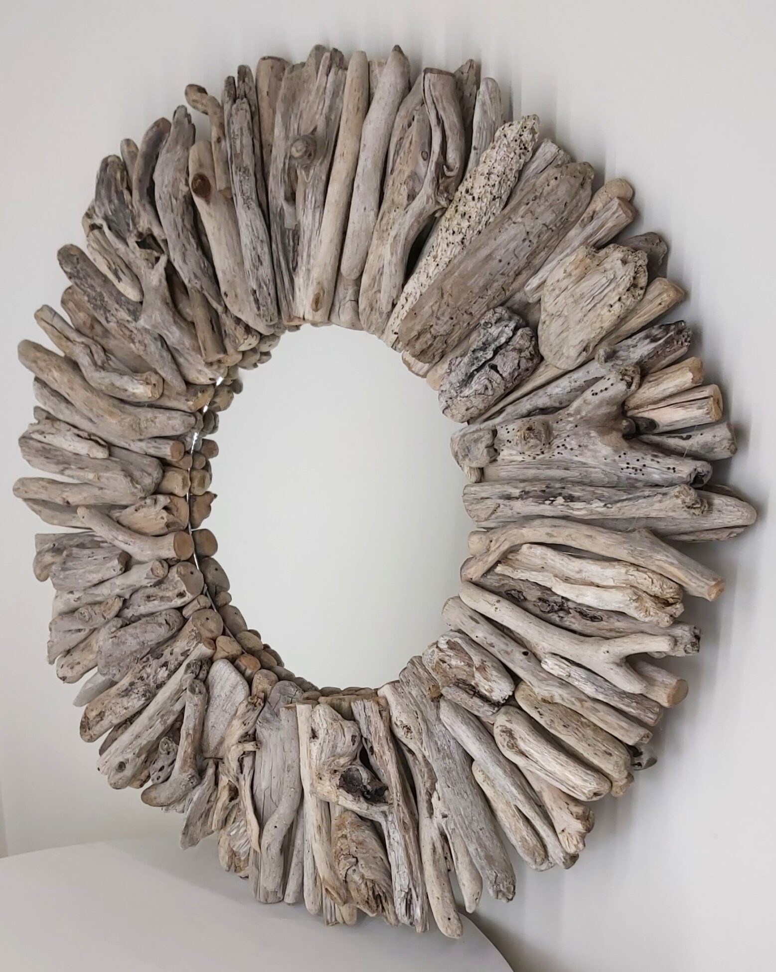 This driftwood mirror titled Salt Wind uses a light grey coloured woods