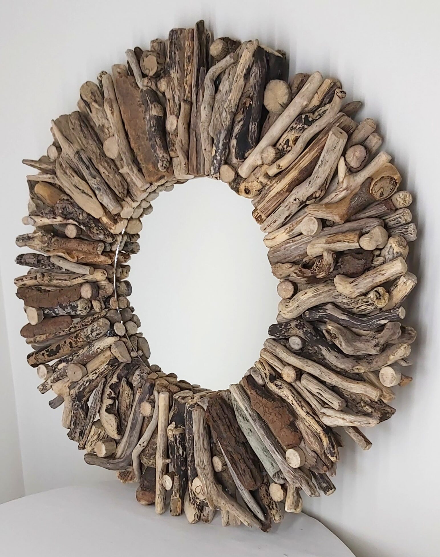 This driftwood mirror titled Sea Spirit uses a mixture of coloured woods