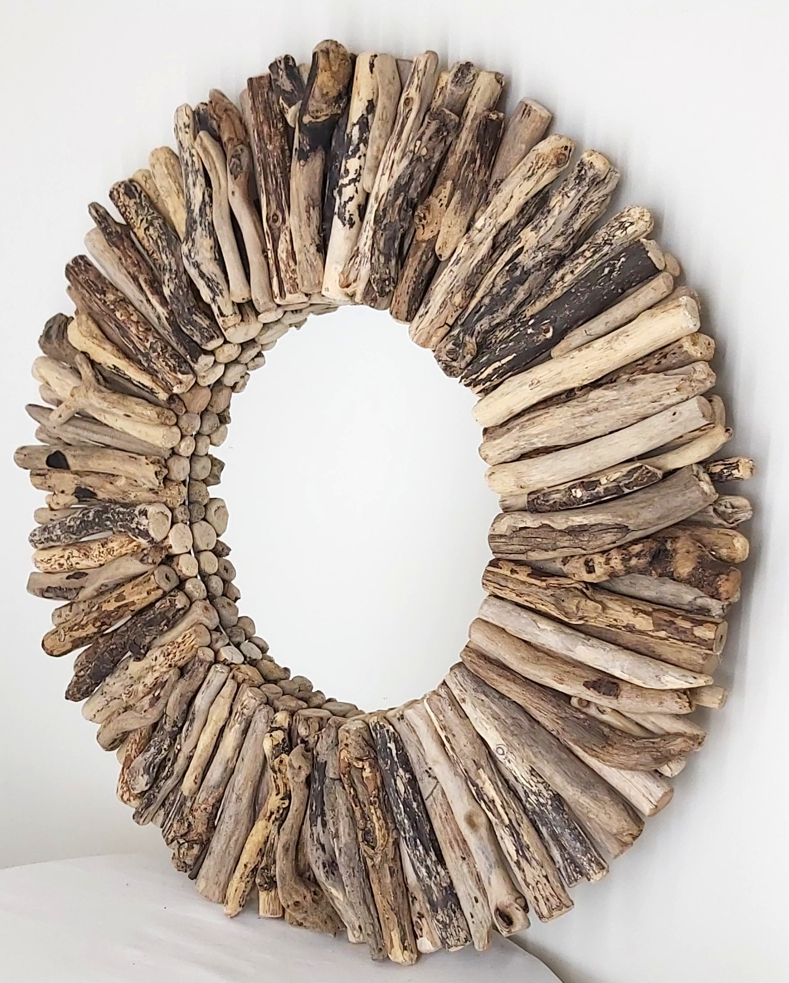 This driftwood mirror titled Spring Sunshine uses a mixture of coloured woods