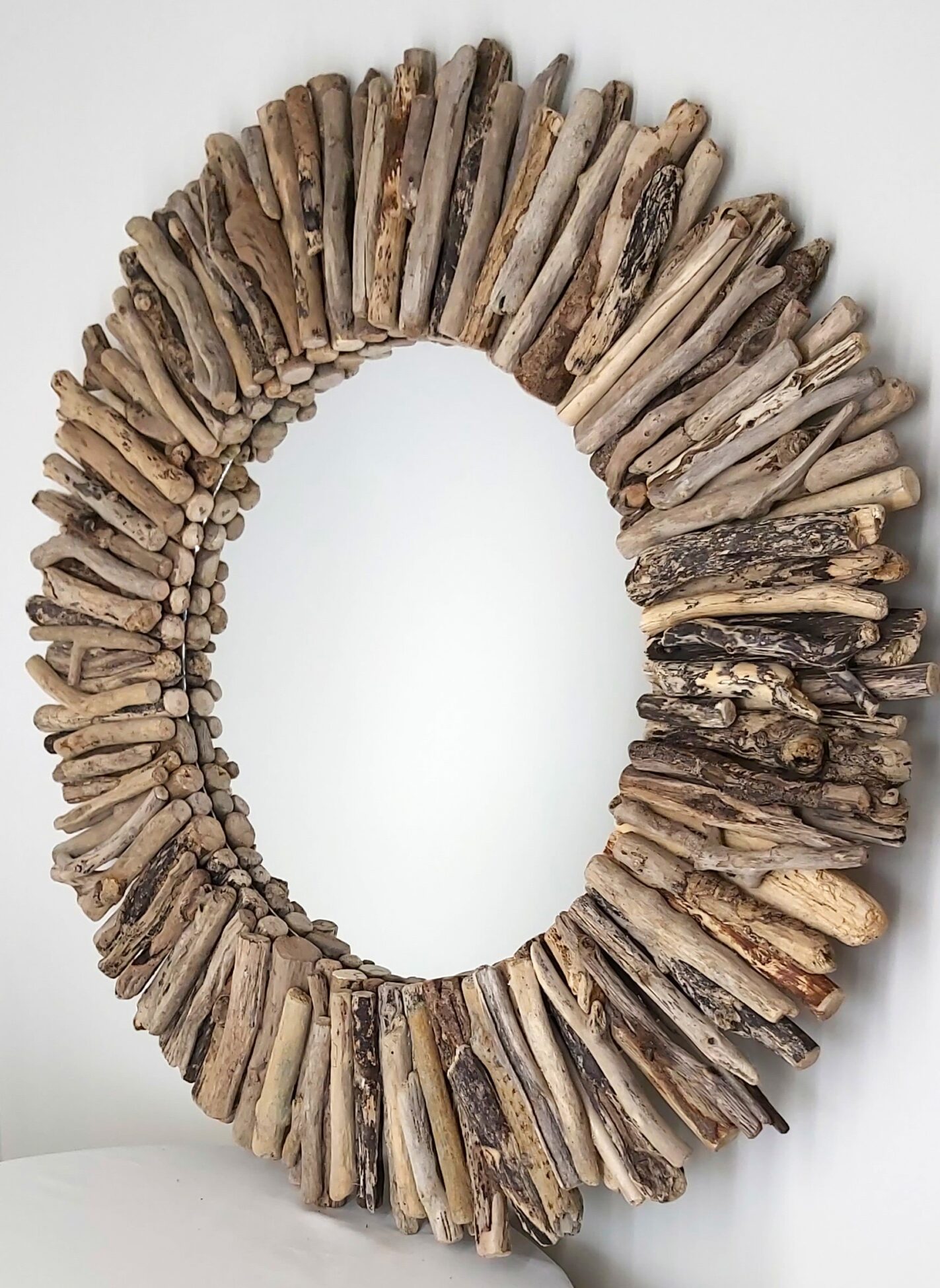This driftwood mirror titled Stormy Beach uses a mixture of coloured woods