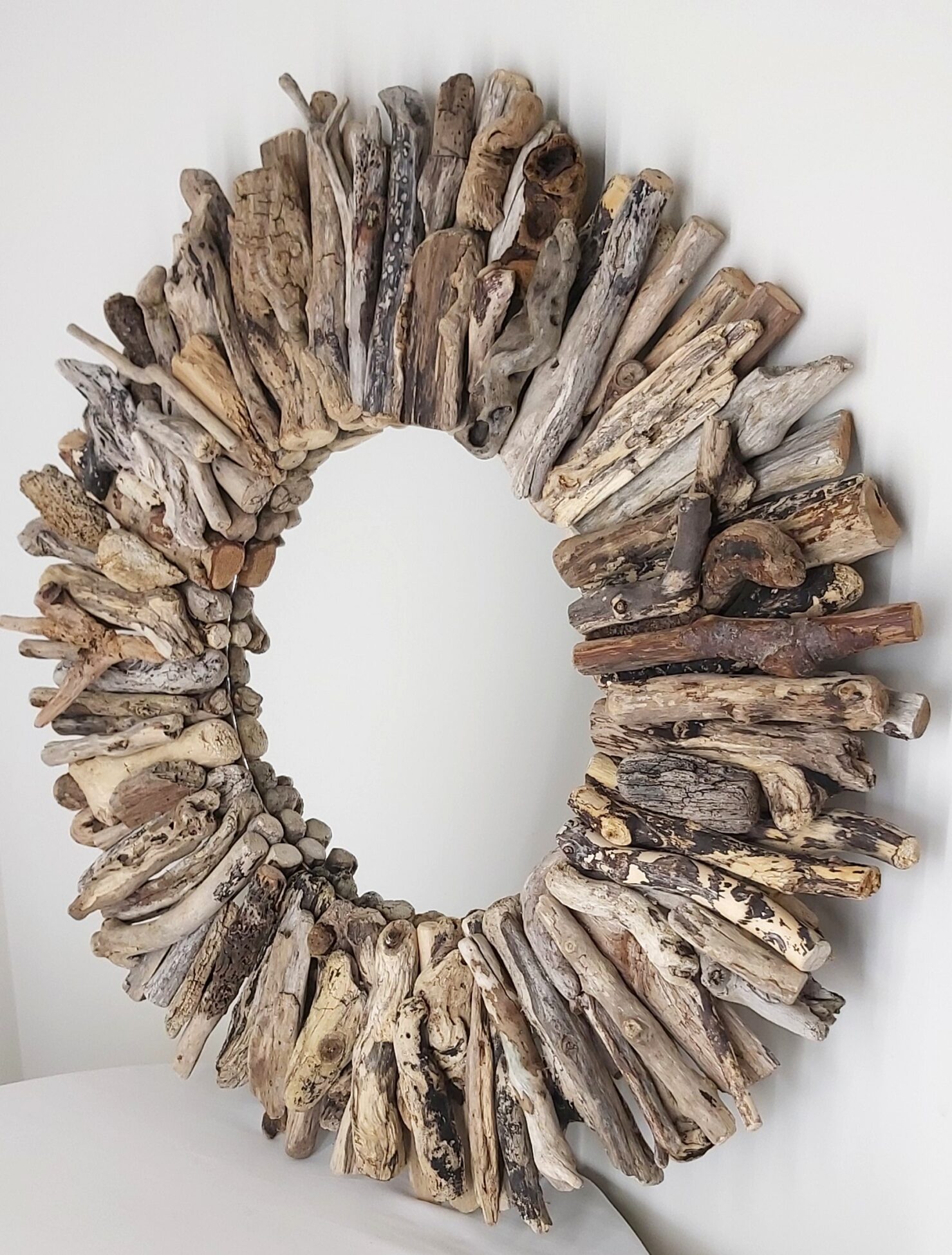 This driftwood mirror titled Winter Beach uses a mixture of coloured woods