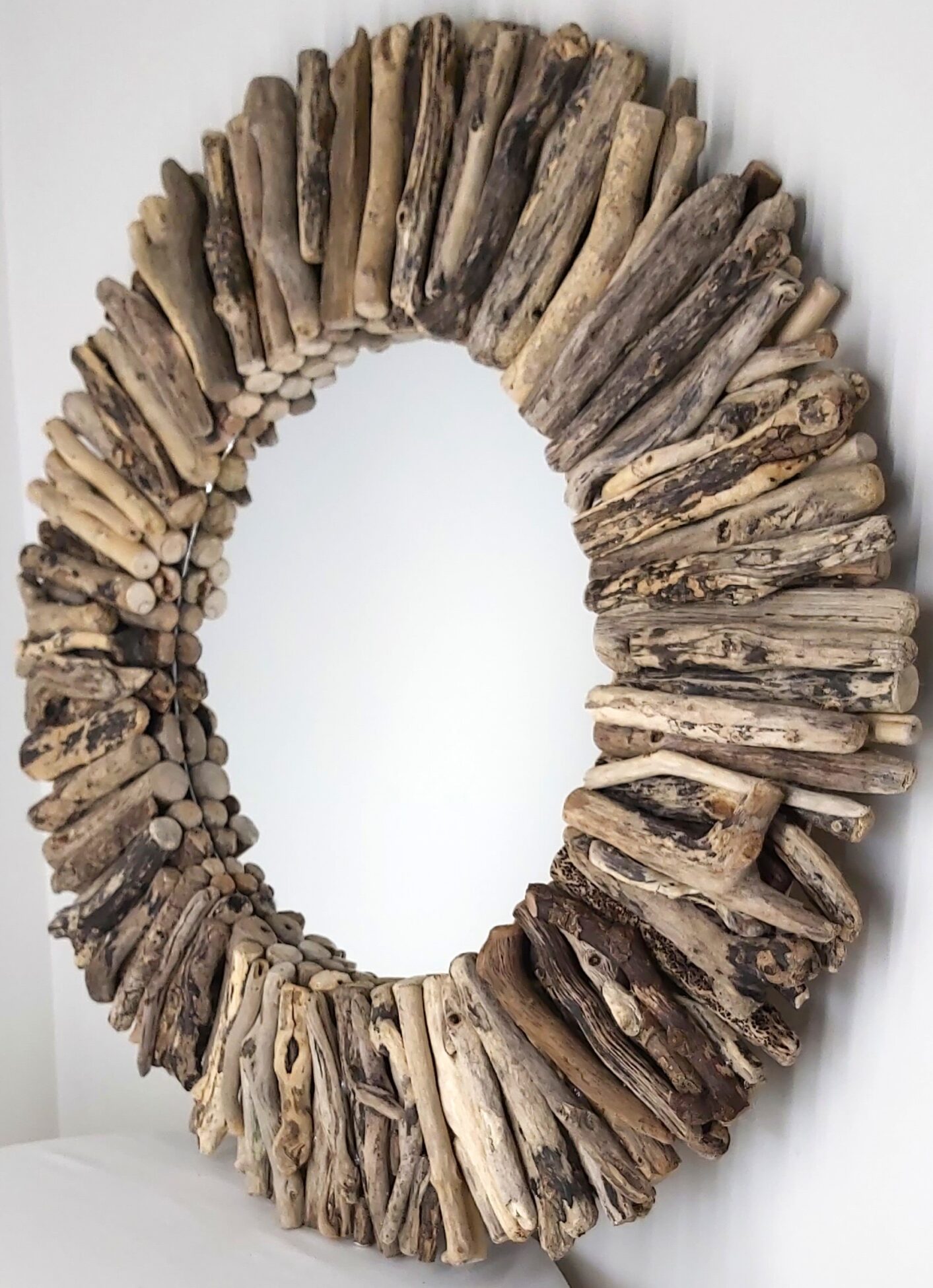 This driftwood mirror titled Winter Sun uses a mixture of coloured woods