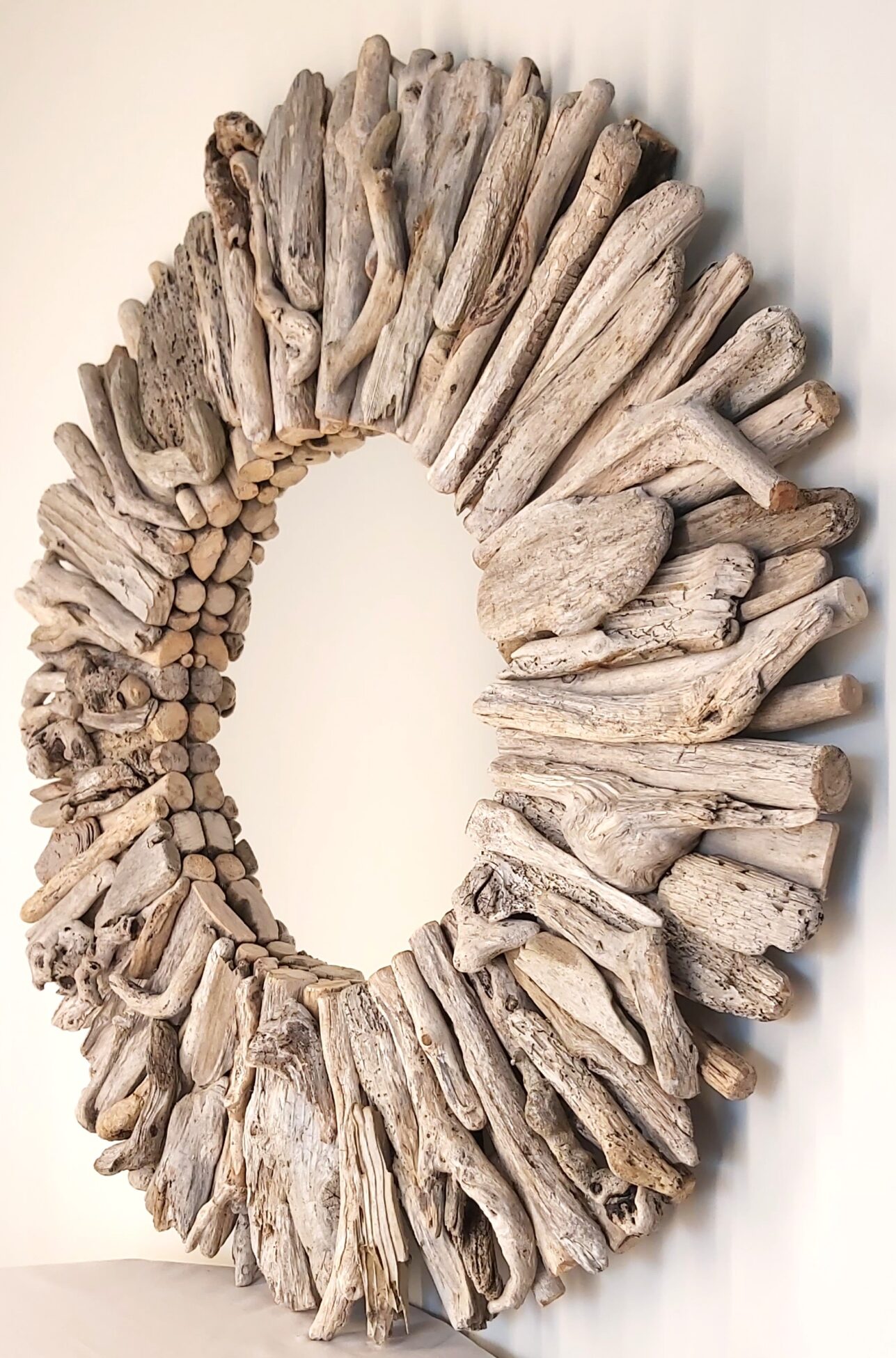This driftwood mirror titled Ocean Mystery uses a mixture of light coloured woods