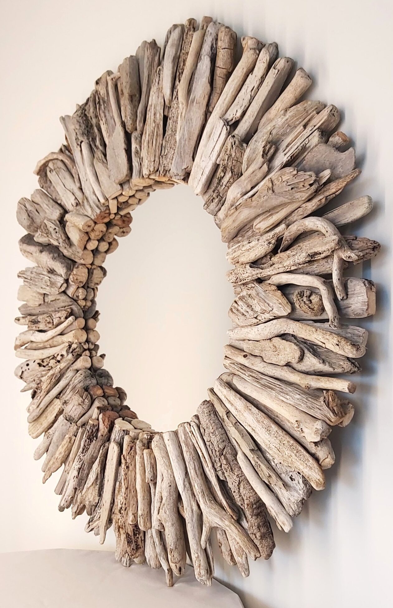 This driftwood mirror titled Ocean Spell uses a mixture of light coloured woods