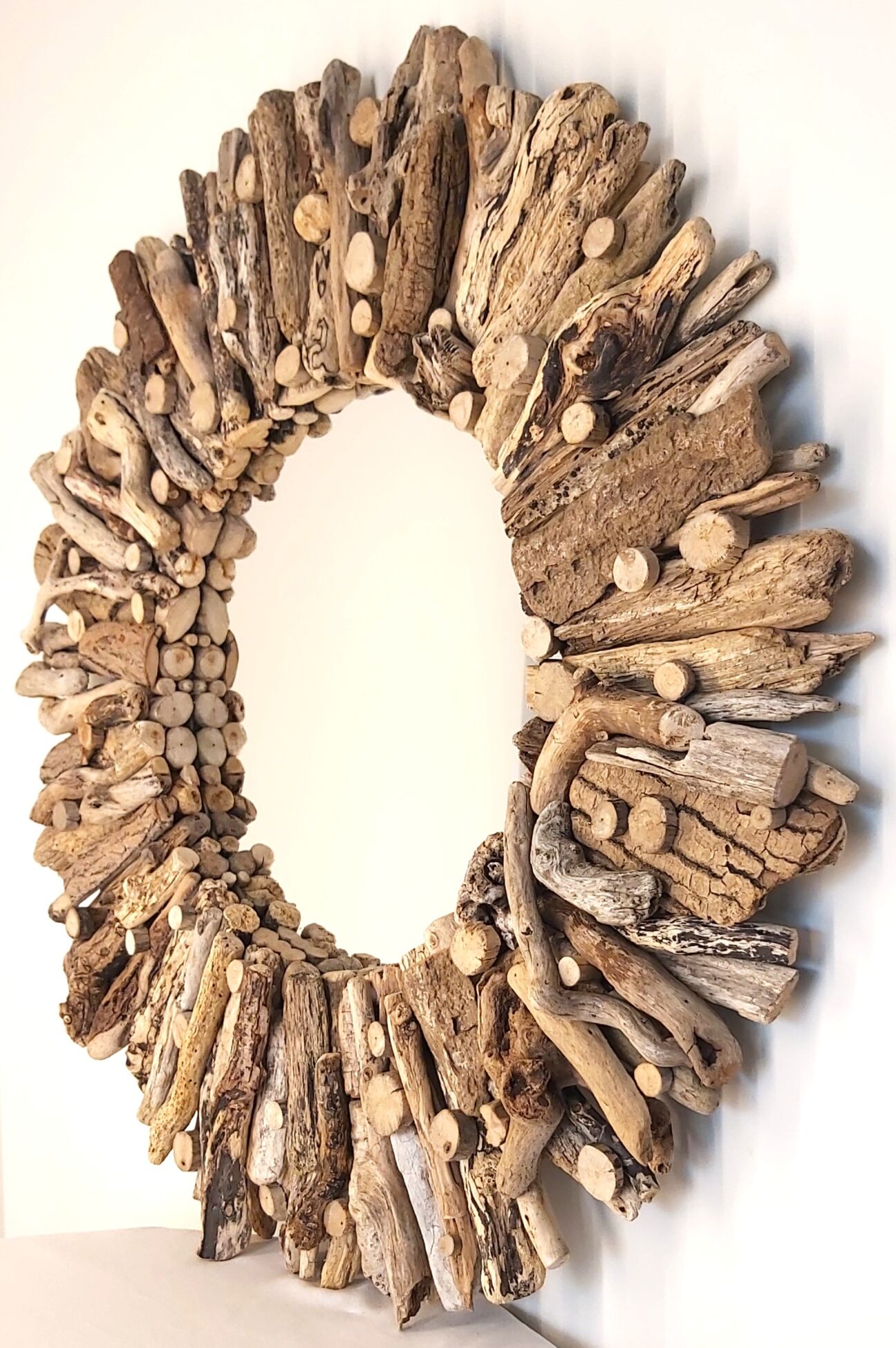 This driftwood mirror titled Sea, Sun and Sand uses a mixture of golden coloured woods