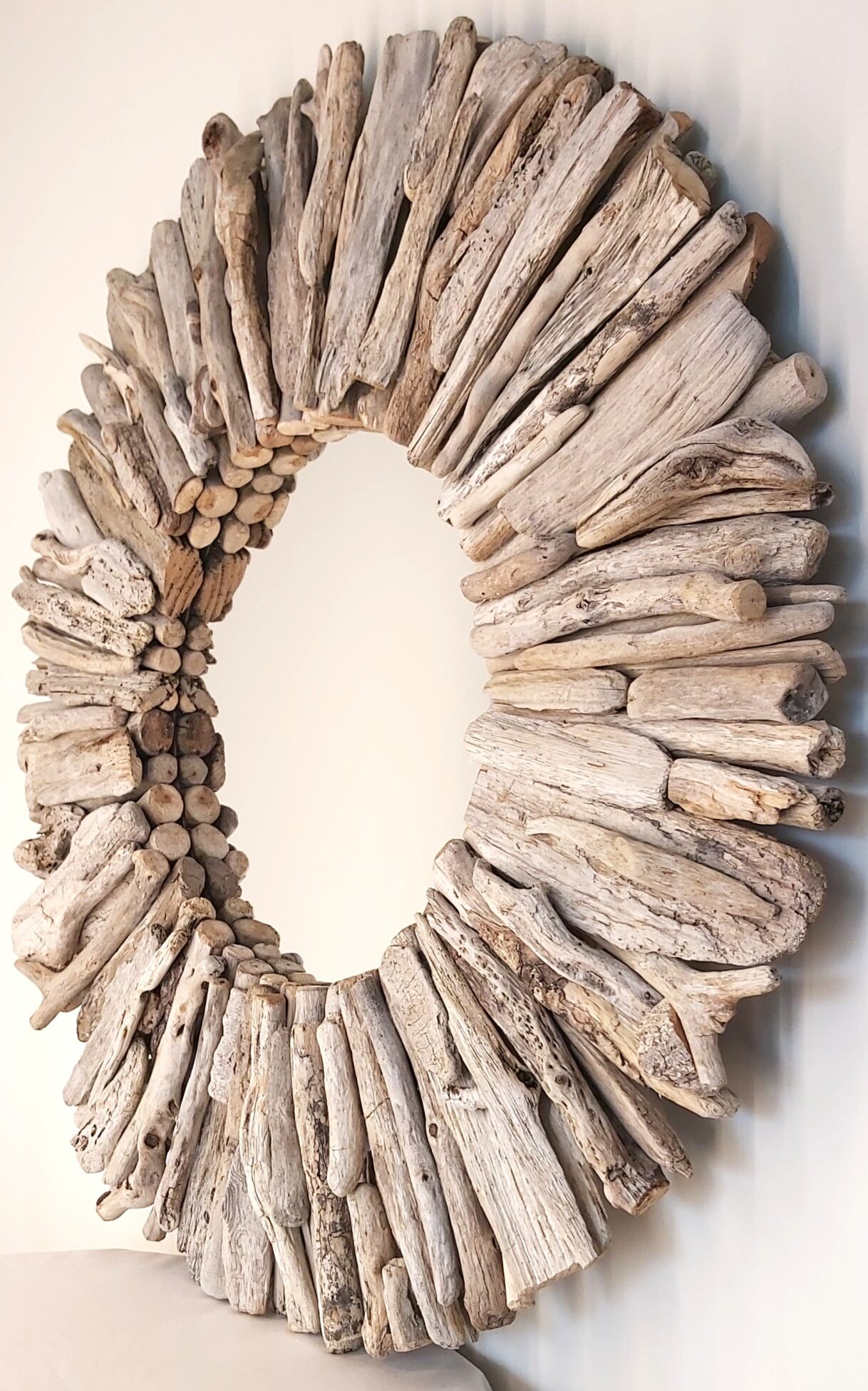This driftwood mirror titled Silver Sea uses a mixture of light grey woods
